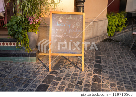 Signboard on the street. Menu board stand. Restaurant sidewalk chalkboard sign board. Signboard on the street. Menu board stand. Restaurant sidewalk chalkboard sign board. 119710563