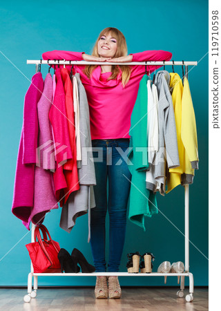 Woman choosing clothes to wear in mall or wardrobe 119710598