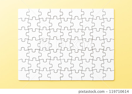 Plain jigsaw puzzle on a yellow background Plain jigsaw puzzle on a yellow background 119710614