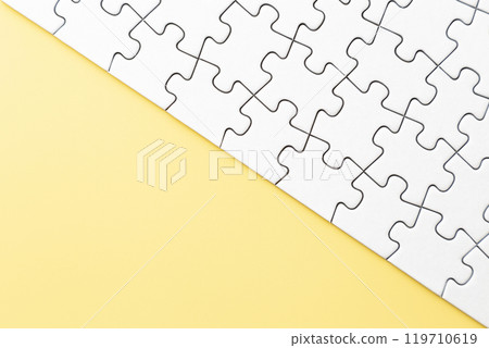 Plain jigsaw puzzle on a yellow background Plain jigsaw puzzle on a yellow background 119710619