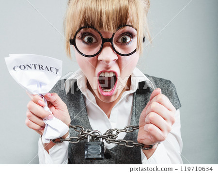 Furious woman with chained hands and contract 119710634