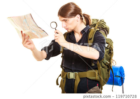 Man tourist reading map with magnifying glass Man tourist reading map with magnifying glass 119710728