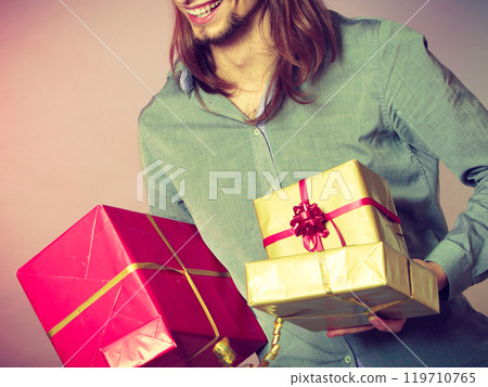 Guy with many presents gift boxes Guy with many presents gift boxes 119710765