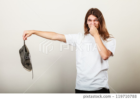 Man with stinky shoe Man with stinky shoe 119710788
