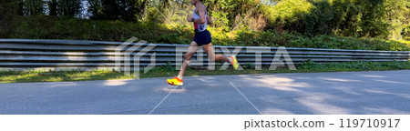 side view athlete runner running marathon race on asphalt road side view athlete runner running marathon race on asphalt road 119710917