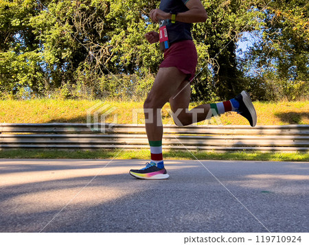 male athlete runner running race on road in park male athlete runner running race on road in park 119710924