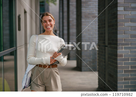 A Smiling Young Professional in a Modern Urban Setting, Exuding Passion and Confidence 119710982