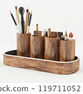 Elegant wood makeup brush holder with various cosmetic tools on white background 119711052