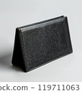 Elegant black leather clutch handbag on white background in modern fashion accessory design 119711063