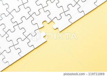 Plain jigsaw puzzle on a yellow background 119711069