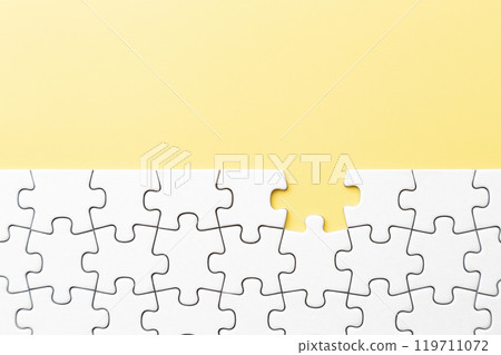 Plain jigsaw puzzle on a yellow background Plain jigsaw puzzle on a yellow background 119711072