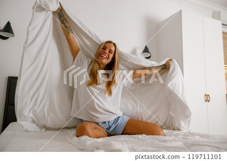 A Blissful and Joyful Morning Moment in a Brightly Lit and Inviting Bedroom Space A Blissful and Joyful Morning Moment in a Brightly Lit and Inviting Bedroom Space 119711101