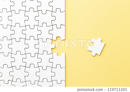 Plain jigsaw puzzle on a yellow background 119711203