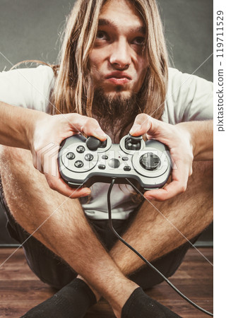 Male player focus on play games Male player focus on play games 119711529