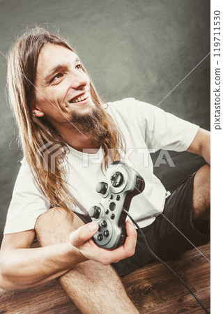 Happy man playing games Happy man playing games 119711530