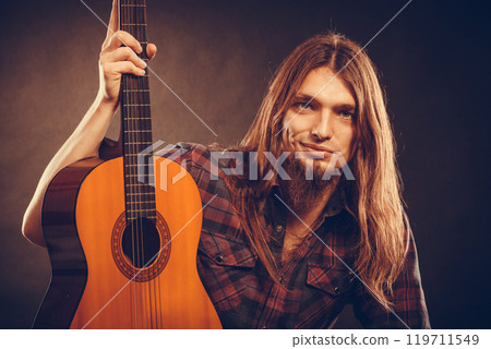 Young man holding guitar. Young man holding guitar. 119711549