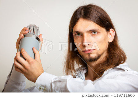 Young bartender shaking glasses. 119711600