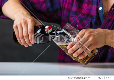 Tapster fills stein from bottle. Tapster fills stein from bottle. 119711668