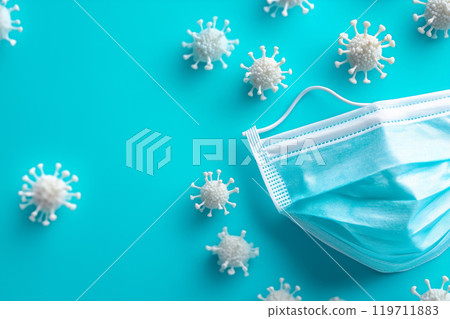 Mask set among virus models on a blue background for health awareness campaign 119711883
