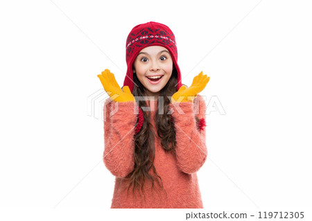 Girl wearing trendy outfit with knitted beanie hat. Girl with winter hat isolated on white. Winter fashion style trend. Teen girl in hat enjoying childhood. Knitted accessories Girl wearing trendy outfit with knitted beanie hat. Girl with winter hat isolated on white. Winter fashion style trend. Teen girl in hat enjoying childhood. Knitted accessories 119712305