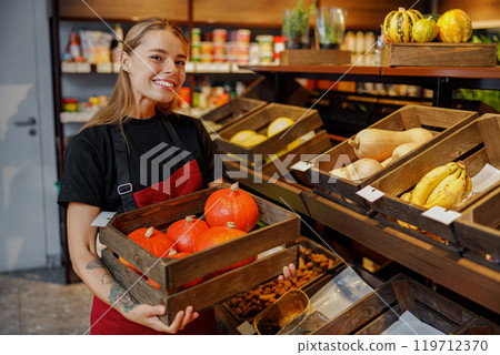 A Friendly Neighborhood Shopkeeper Offering Fresh and Colorful Vegetables in a Local Market 119712370