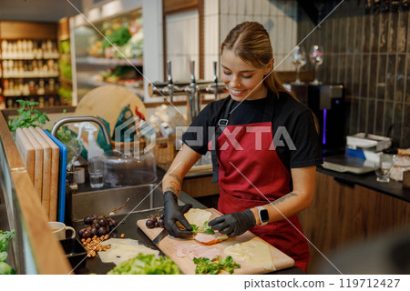 A Young Chef Skills at Preparing Fresh Ingredients in a Bright, Modern Kitchen Setting 119712427