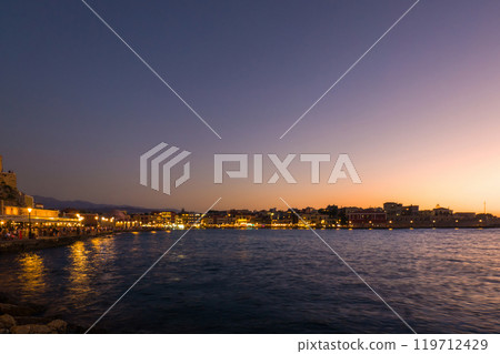 A busy port area with lights coming on after sunset (Old Town of Chania, Crete, Greece) 119712429