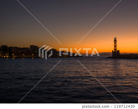 Old lighthouse illuminated in the dim light of the port after sunset (Old Town of Chania, Crete, Greece) Old lighthouse illuminated in the dim light of the port after sunset (Old Town of Chania, Crete, Greece) 119712430