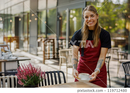 Friendly Barista Serving Coffee at a Modern Caf Friendly Barista Serving Coffee at a Modern Caf 119712480