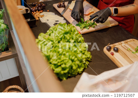 Preparation of Fresh Ingredients in a Contemporary, Stylish Modern Kitchen Space 119712507