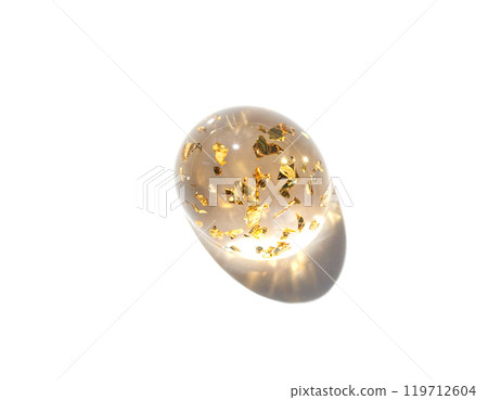 Transparent resin sphere with gold leaf particles on white background Transparent resin sphere with gold leaf particles on white background 119712604