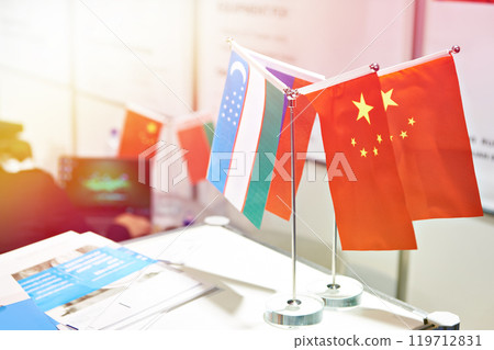 Flags of China and Uzbekistan at business exhibition 119712831