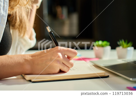 Illustrator drawing sketches in notebook at home office desk Illustrator drawing sketches in notebook at home office desk 119713036