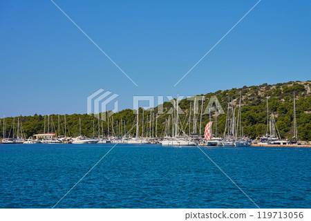 Modern yachts and boats docking in marina on sunny summer day Modern yachts and boats docking in marina on sunny summer day 119713056