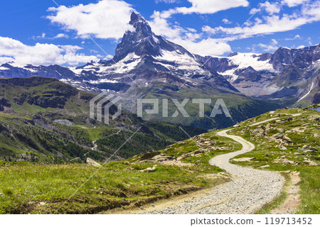 famous hiking routes in Switzerland , Valais canton - five most beautiful mountain lakes in Zermatt. floral meadow and  Matterhorn iconic mountain 119713452