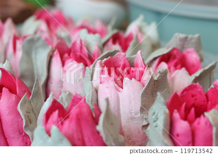 Marshmallow tulips. Marshmallow flowers. Spread out on the table surface. Close-up. Marshmallow tulips. Marshmallow flowers. Spread out on the table surface. Close-up. 119713542