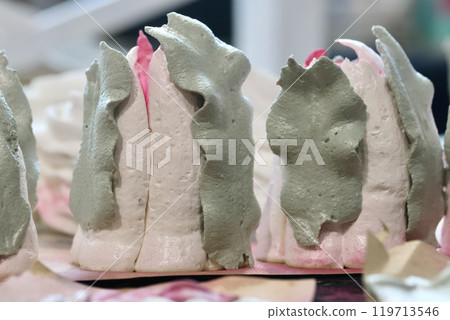 Marshmallow tulips. Marshmallow flowers. Spread out on the table surface. Close-up. Marshmallow tulips. Marshmallow flowers. Spread out on the table surface. Close-up. 119713546