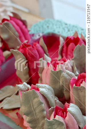 Marshmallow tulips. Marshmallow flowers. Spread out on the table surface. Close-up. Marshmallow tulips. Marshmallow flowers. Spread out on the table surface. Close-up. 119713547