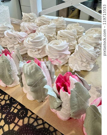 Homemade marshmallows on the table surface. They are setting and stabilizing before packaging. The marshmallows are classic. Marshmallow tulips. 119713553