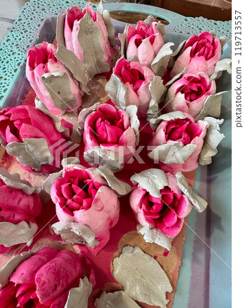 Bright pink marshmallow tulips. Marshmallow flowers. Spread out on the table surface. 119713557