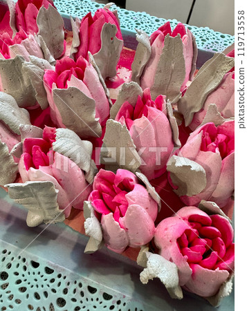 Bright pink marshmallow tulips. Marshmallow flowers. Spread out on the table surface. 119713558