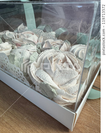 Marshmallow flowers in a gift box with a transparent lid. Homemade marshmallows as a gift. Close-up. Marshmallow flowers in a gift box with a transparent lid. Homemade marshmallows as a gift. Close-up. 119713572