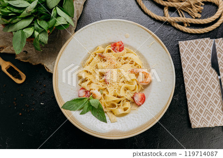 Creamy pasta with shrimp, mushrooms, Parmesan, and fresh basil, served in an elegant setting Creamy pasta with shrimp, mushrooms, Parmesan, and fresh basil, served in an elegant setting 119714087