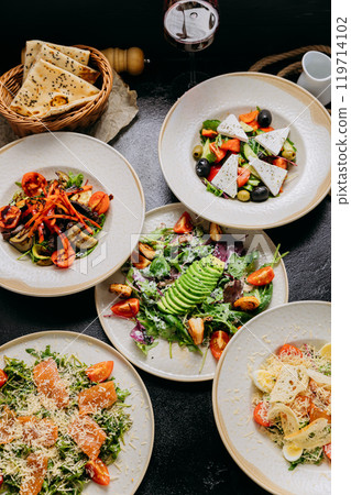 Gourmet salads with various ingredients including avocado, feta, grilled vegetables and salmon Gourmet salads with various ingredients including avocado, feta, grilled vegetables and salmon 119714102