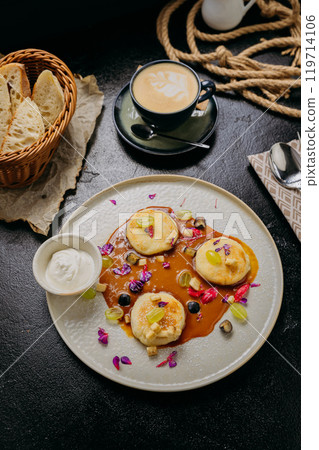 Gourmet pancakes with caramel sauce, fresh fruits, edible flowers, and sour cream Gourmet pancakes with caramel sauce, fresh fruits, edible flowers, and sour cream 119714106