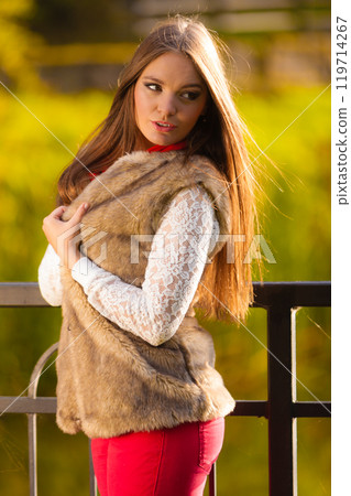 Portrait girl relaxing walking in autumnal park. 119714267