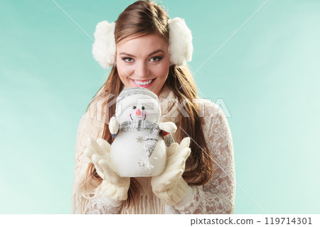 Smiling cute woman with little snowman. Winter. 119714301