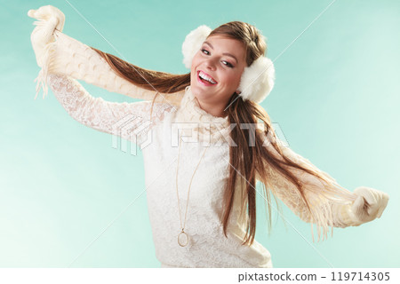 Smiling cute pretty woman girl in earmuffs. Smiling cute pretty woman girl in earmuffs. 119714305