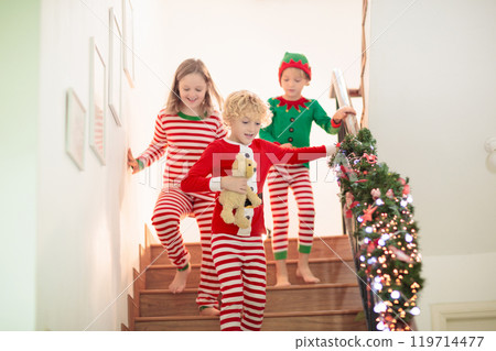 Kids running stair on Christmas morning 119714477