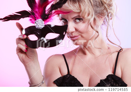 Woman middle aged holds carnival mask. Woman middle aged holds carnival mask. 119714585